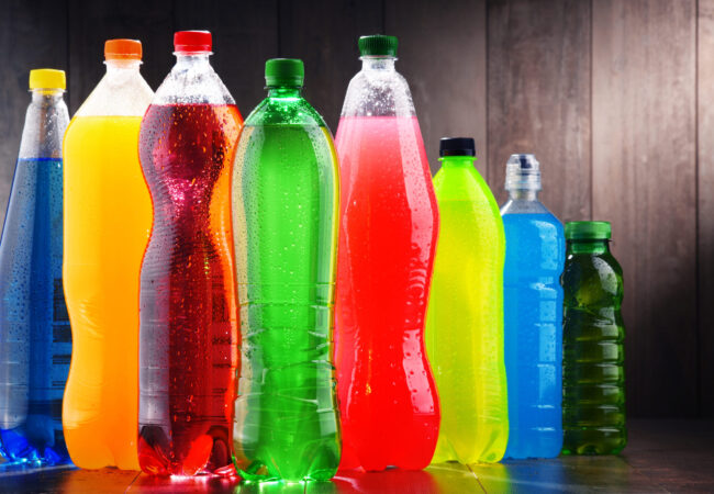 Plastic bottles of assorted carbonated soft drinks in variety of colors