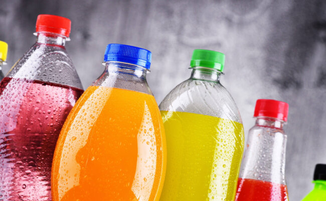 Plastic bottles of assorted carbonated soft drinks in variety of colors